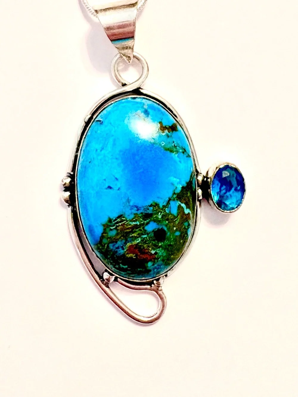 2 1/2 inch, 925 marked, Turquoise and Blue Topaz pendant on a silver chain.